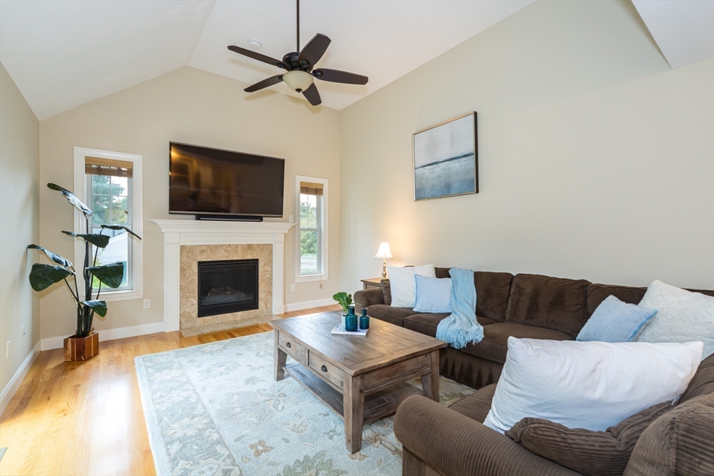 9 Flynn Street Natick, MA 01760 - Photo 15 of 36 a living room with furniture a flat screen tv and a fireplace