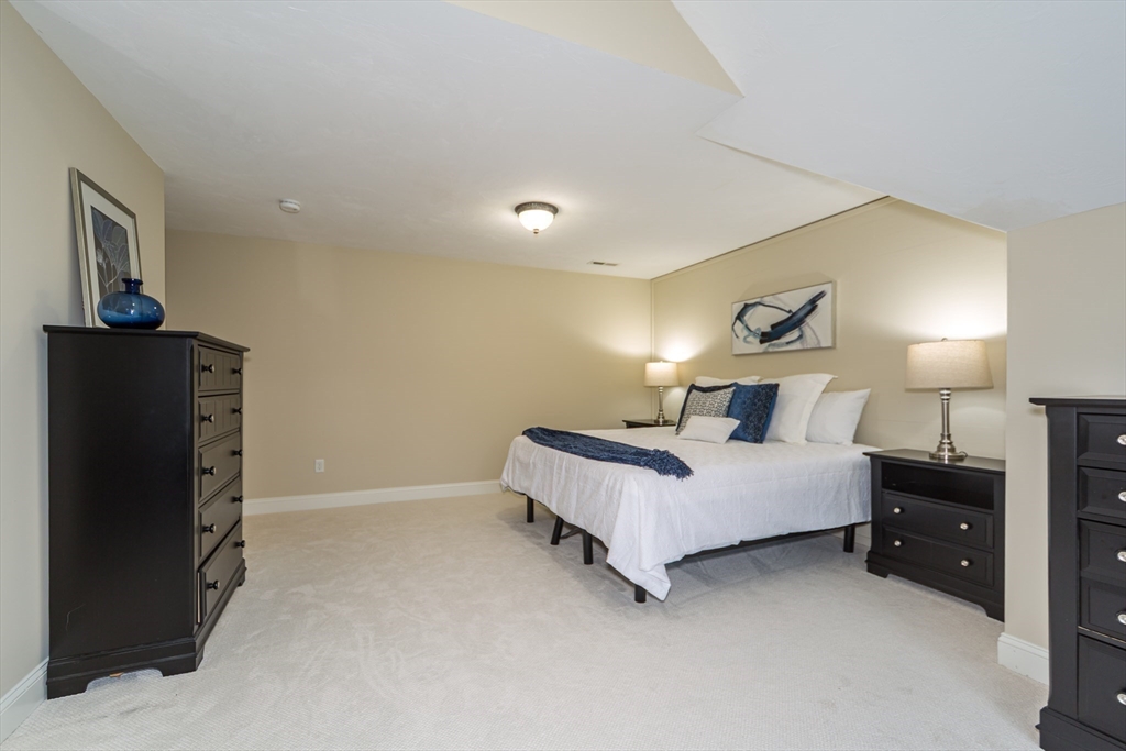 9 Flynn Street Natick, MA 01760 - Photo 20 of 36 a bed room with a bed and mirror