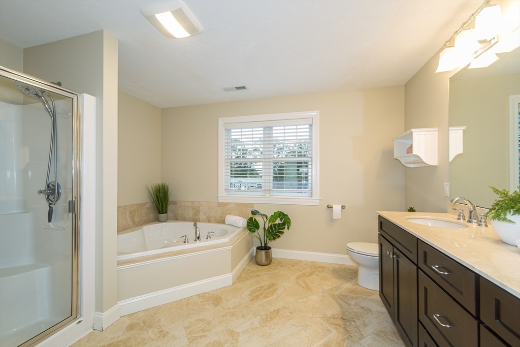 9 Flynn Street Natick, MA 01760 - Photo 21 of 36 a bathroom with a tub sink and mirror