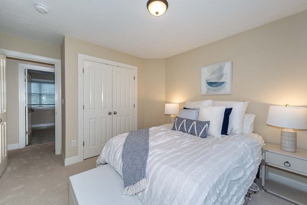 9 Flynn Street Natick, MA 01760 - Photo 22 of 36 a bedroom with a bed and a lamp