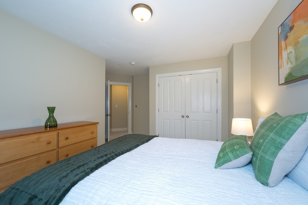 9 Flynn Street Natick, MA 01760 - Photo 25 of 36 a bedroom with a bed and a potted plant