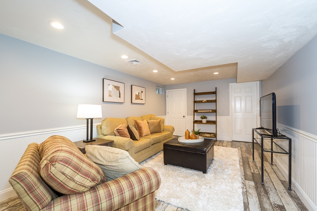 9 Flynn Street Natick, MA 01760 - Photo 30 of 36 a spacious bedroom with a bed and couch