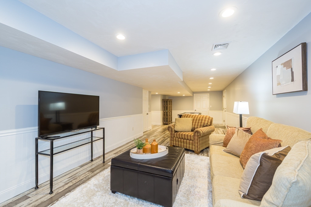 9 Flynn Street Natick, MA 01760 - Photo 31 of 36 a living room with furniture and a flat screen tv