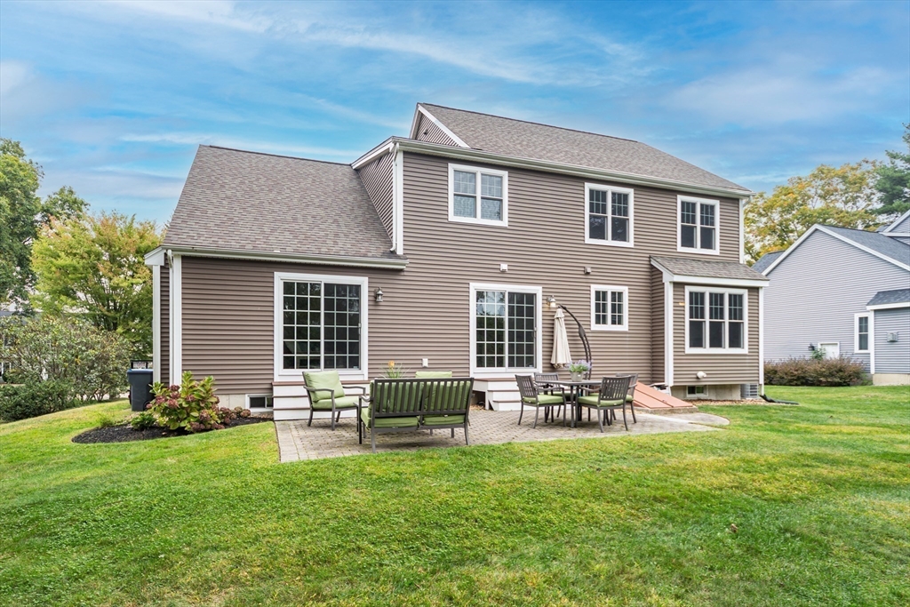 9 Flynn Street Natick, MA 01760 - Photo 35 of 36 a backyard of a house with table and chairs