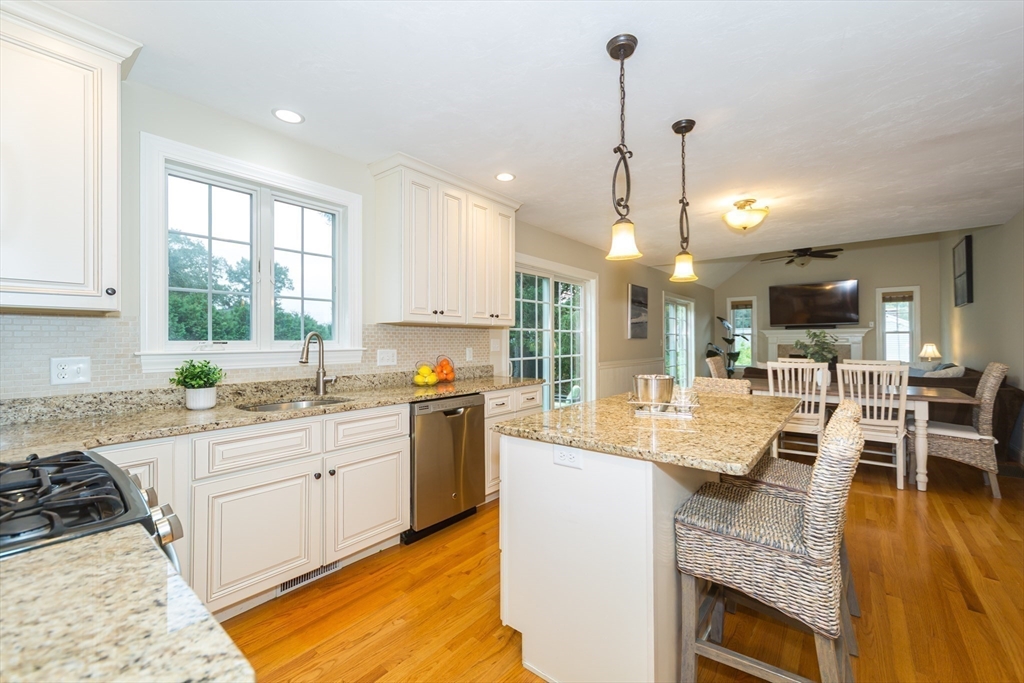 9 Flynn Street Natick, MA 01760 - Photo 10 of 36 a large kitchen with kitchen island granite countertop a large center island attached withe living room