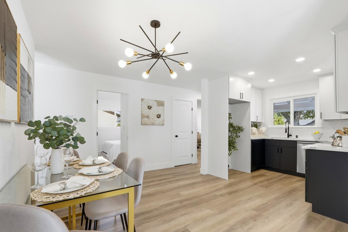 2837 Burdick Way San Jose, CA 95148 - Photo 1 of 1 a kitchen with stainless steel appliances kitchen island granite countertop a refrigerator a stove a sink dishwasher and a dining table with wooden floor