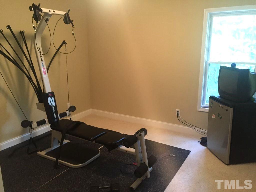 3136 La Costa Way Raleigh, NC 27610 - Photo 15 of 21 a room with gym equipment and a flat screen tv