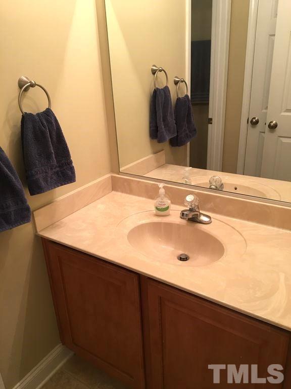 3136 La Costa Way Raleigh, NC 27610 - Photo 18 of 21 a bathroom with a sink and a mirror