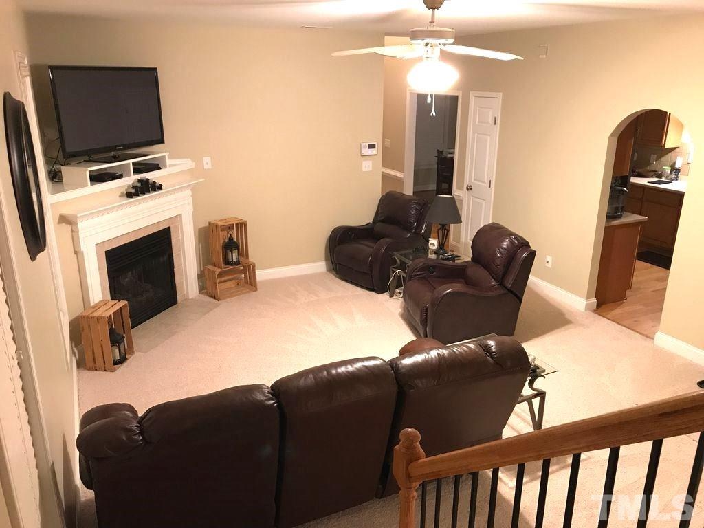 3136 La Costa Way Raleigh, NC 27610 - Photo 4 of 21 a living room with furniture a flat screen tv and kitchen view