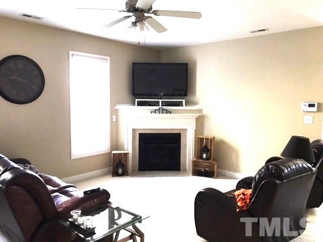 3136 La Costa Way Raleigh, NC 27610 - Photo 5 of 21 a living room with furniture a fireplace and a flat screen tv
