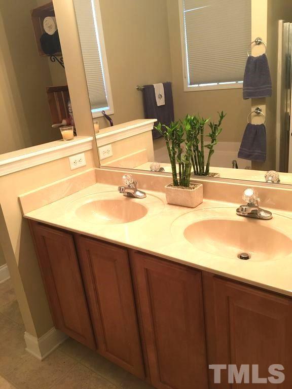 3136 La Costa Way Raleigh, NC 27610 - Photo 10 of 21 a bathroom with a sink and a mirror