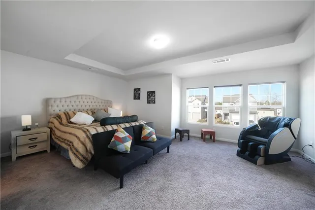 a bedroom with bed and glass window