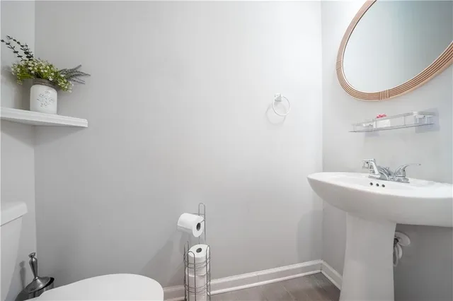 a bathroom with a sink mirror and toilet