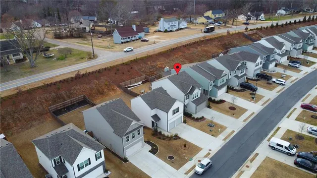an aerial view of residential houses with outdoor space