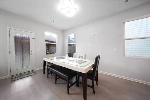 a view of a dining room with furniture and window