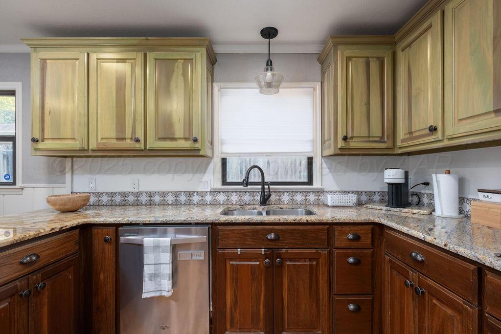 4314 Emil Avenue Amarillo, TX 79106 - Photo 16 of 44 a kitchen with granite countertop stainless steel appliances sink and cabinets