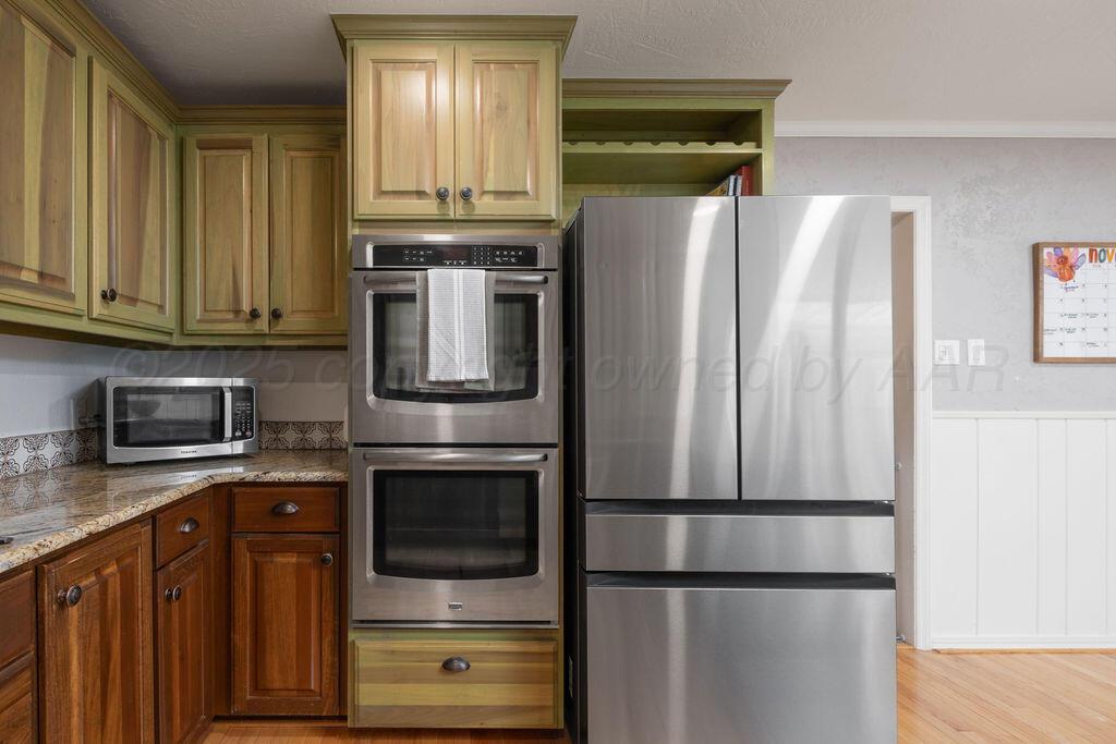 4314 Emil Avenue Amarillo, TX 79106 - Photo 17 of 44 a kitchen with stainless steel appliances granite countertop a refrigerator stove and microwave