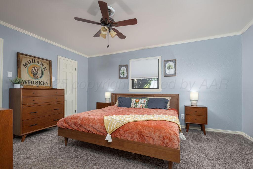 4314 Emil Avenue Amarillo, TX 79106 - Photo 24 of 44 a bedroom with a bed and ceiling fan
