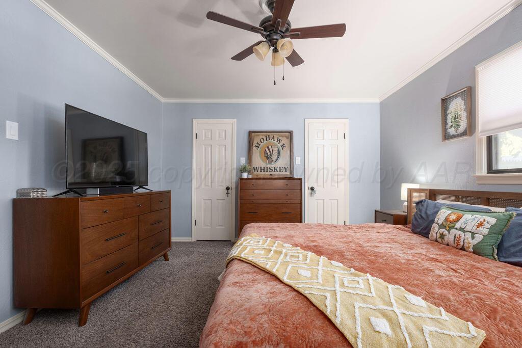 4314 Emil Avenue Amarillo, TX 79106 - Photo 25 of 44 a bedroom with a bed and a flat screen tv