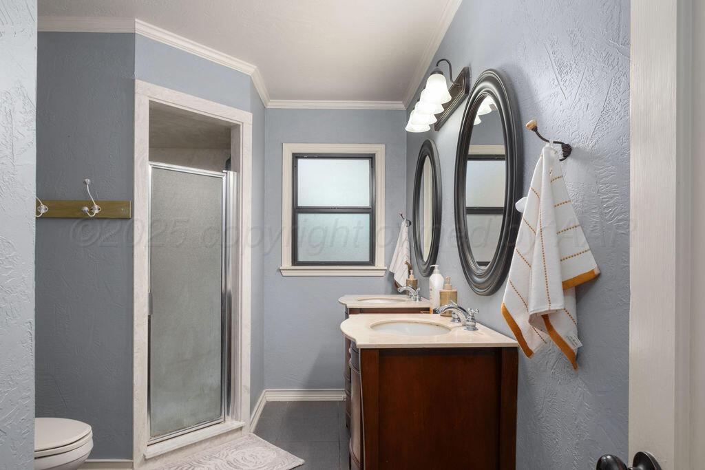 4314 Emil Avenue Amarillo, TX 79106 - Photo 26 of 44 a bathroom with a sink a toilet and a mirror