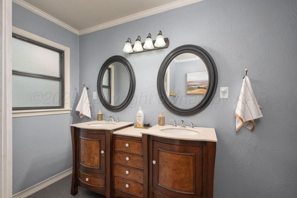 4314 Emil Avenue Amarillo, TX 79106 - Photo 27 of 44 a bathroom with a sink and a mirror