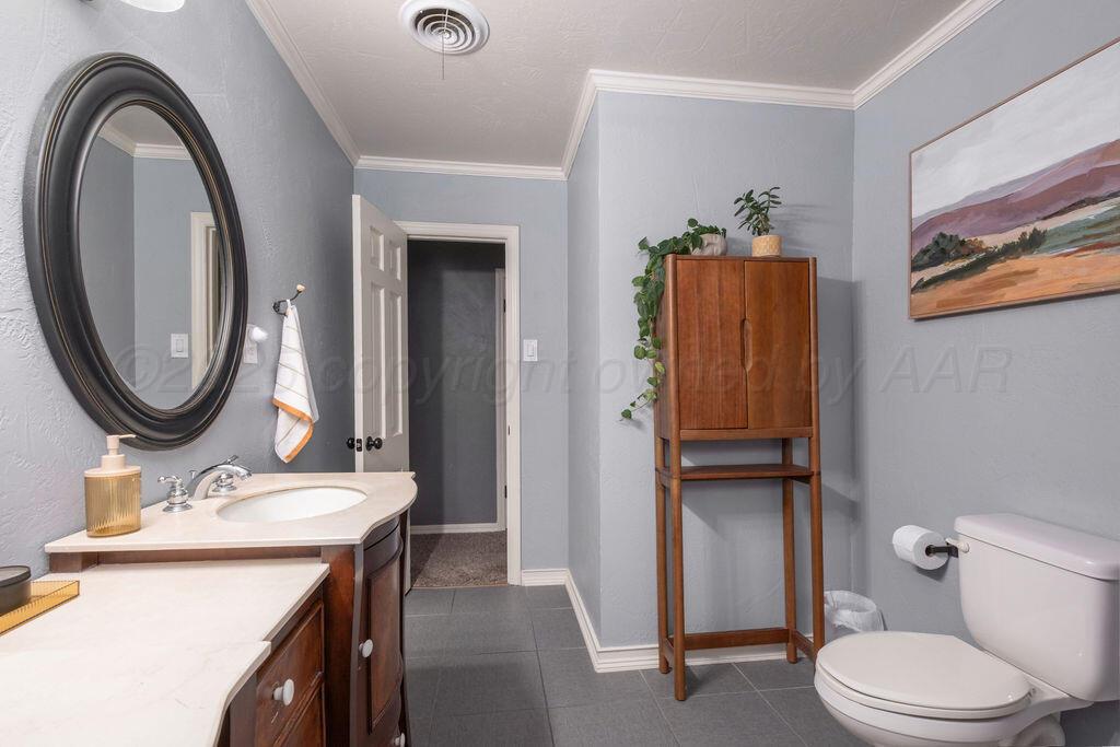 4314 Emil Avenue Amarillo, TX 79106 - Photo 28 of 44 a bathroom with a sink a toilet and a mirror