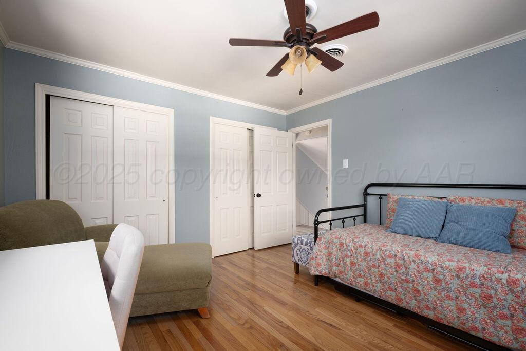 4314 Emil Avenue Amarillo, TX 79106 - Photo 38 of 44 a bedroom with a bed couch and a ceiling fan