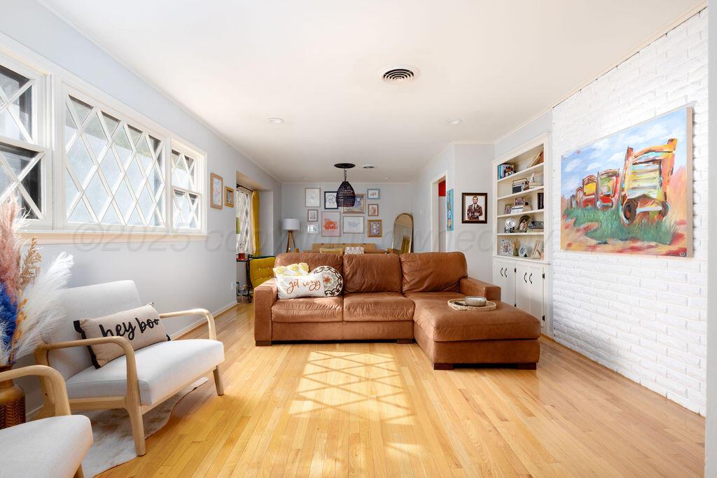 4314 Emil Avenue Amarillo, TX 79106 - Photo 7 of 44 a living room with furniture and a painting on the wall