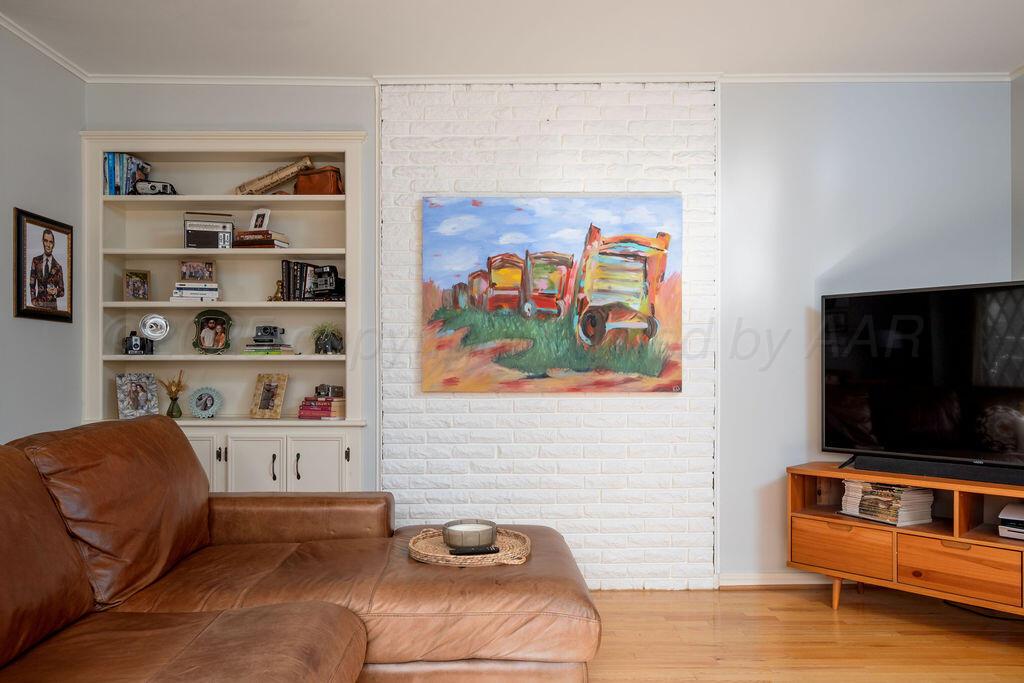4314 Emil Avenue Amarillo, TX 79106 - Photo 9 of 44 a living room with furniture and a flat screen tv