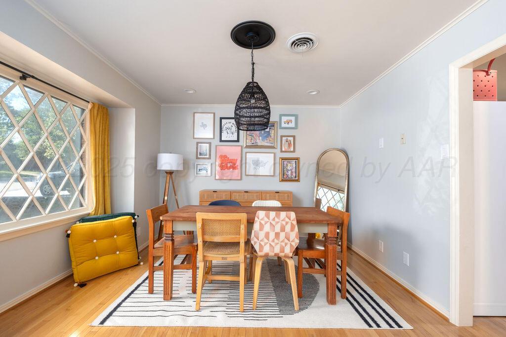 4314 Emil Avenue Amarillo, TX 79106 - Photo 10 of 44 a dining room with furniture a chandelier and wooden floor