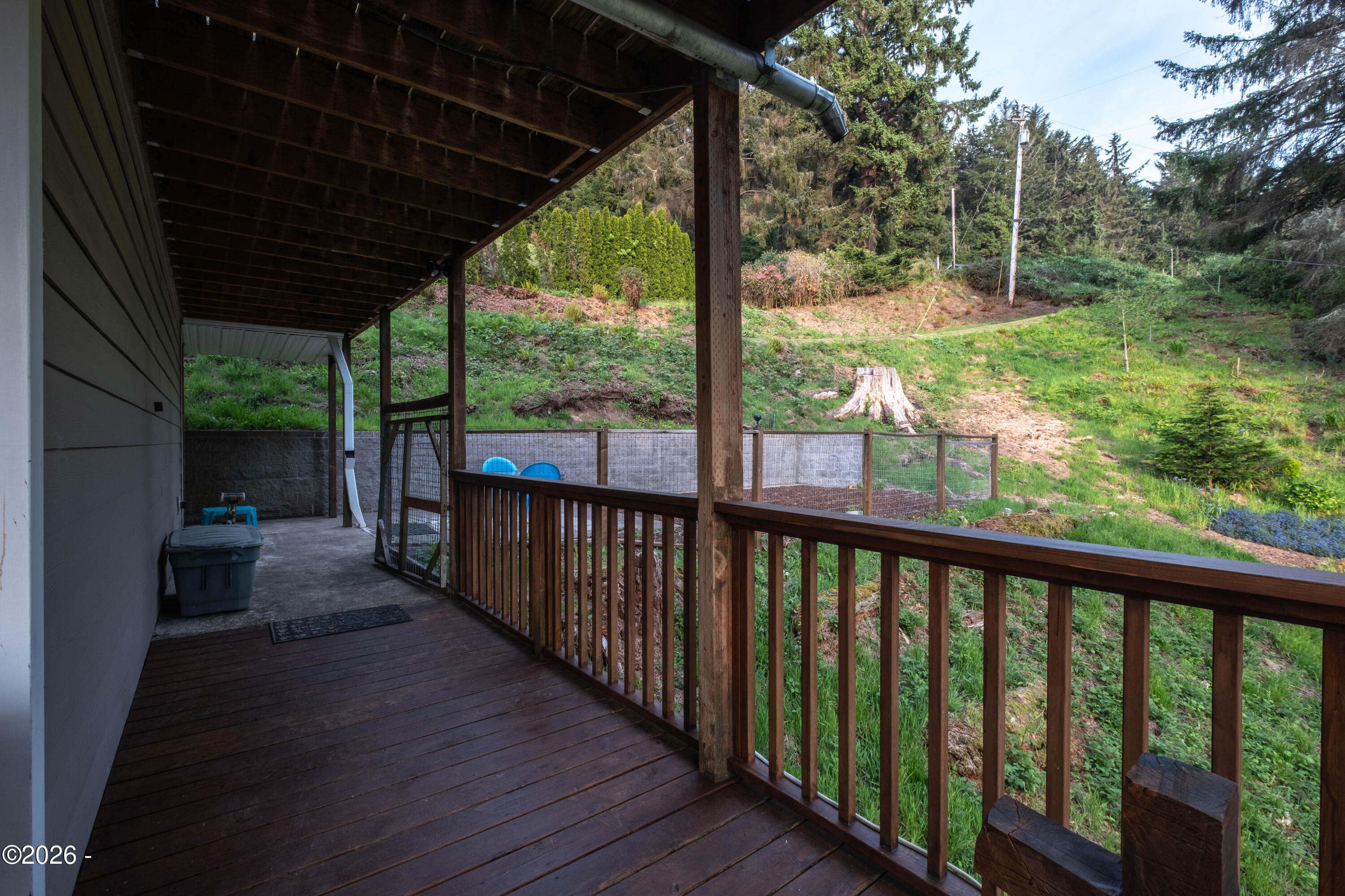 25635 Sandlake Road Cloverdale, OR 97112 - Photo 38 of 49 South side of main level deck with enclosed area for a beloved dog.