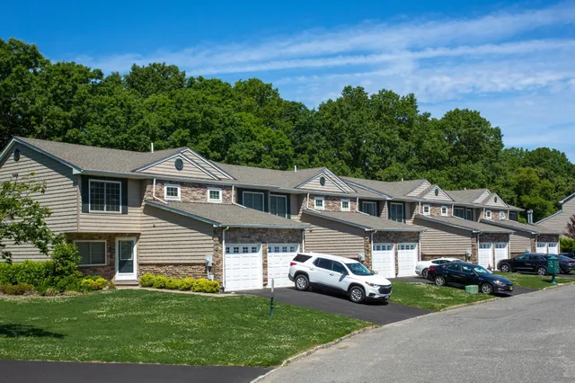 a front view of a house with a garden and parking space