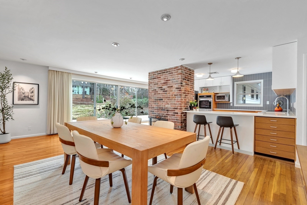 a dining room with furniture and wooden floor