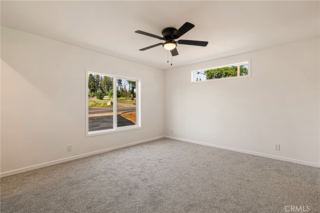 5352 Sawmill Road Paradise, CA 95969 - Photo 13 of 23 an empty room with a window and a ceiling fan