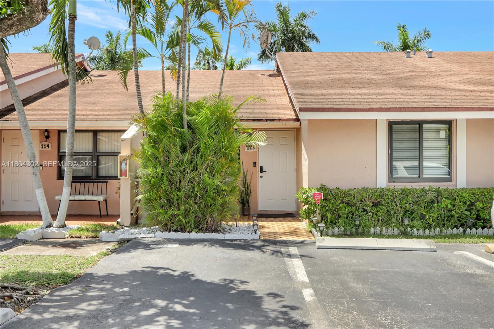 a aerial view of a house with a yard and potted plants