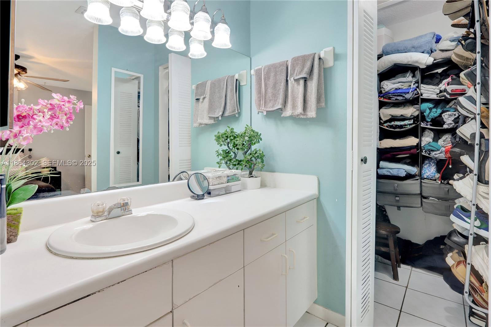 7680 Southwest 156th Court, Unit B113 Miami, FL 33193 - Photo 12 of 16 a bathroom with a sink and a mirror