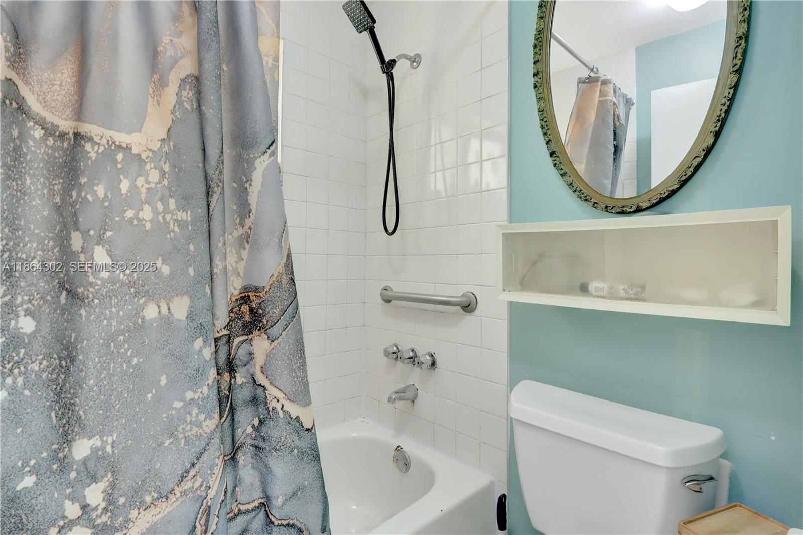 7680 Southwest 156th Court, Unit B113 Miami, FL 33193 - Photo 13 of 16 a bathroom with a toilet sink and mirror