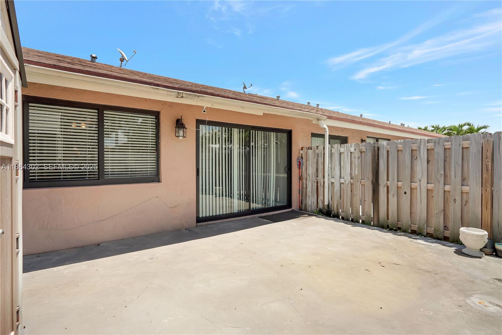 7680 Southwest 156th Court, Unit B113 Miami, FL 33193 - Photo 14 of 16 a view of a house with wooden fence