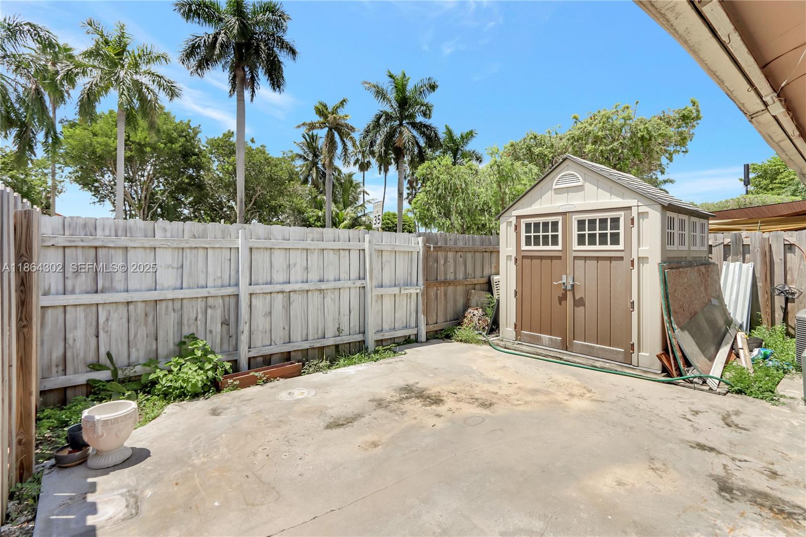 7680 Southwest 156th Court, Unit B113 Miami, FL 33193 - Photo 15 of 16 a front view of a house with a garden