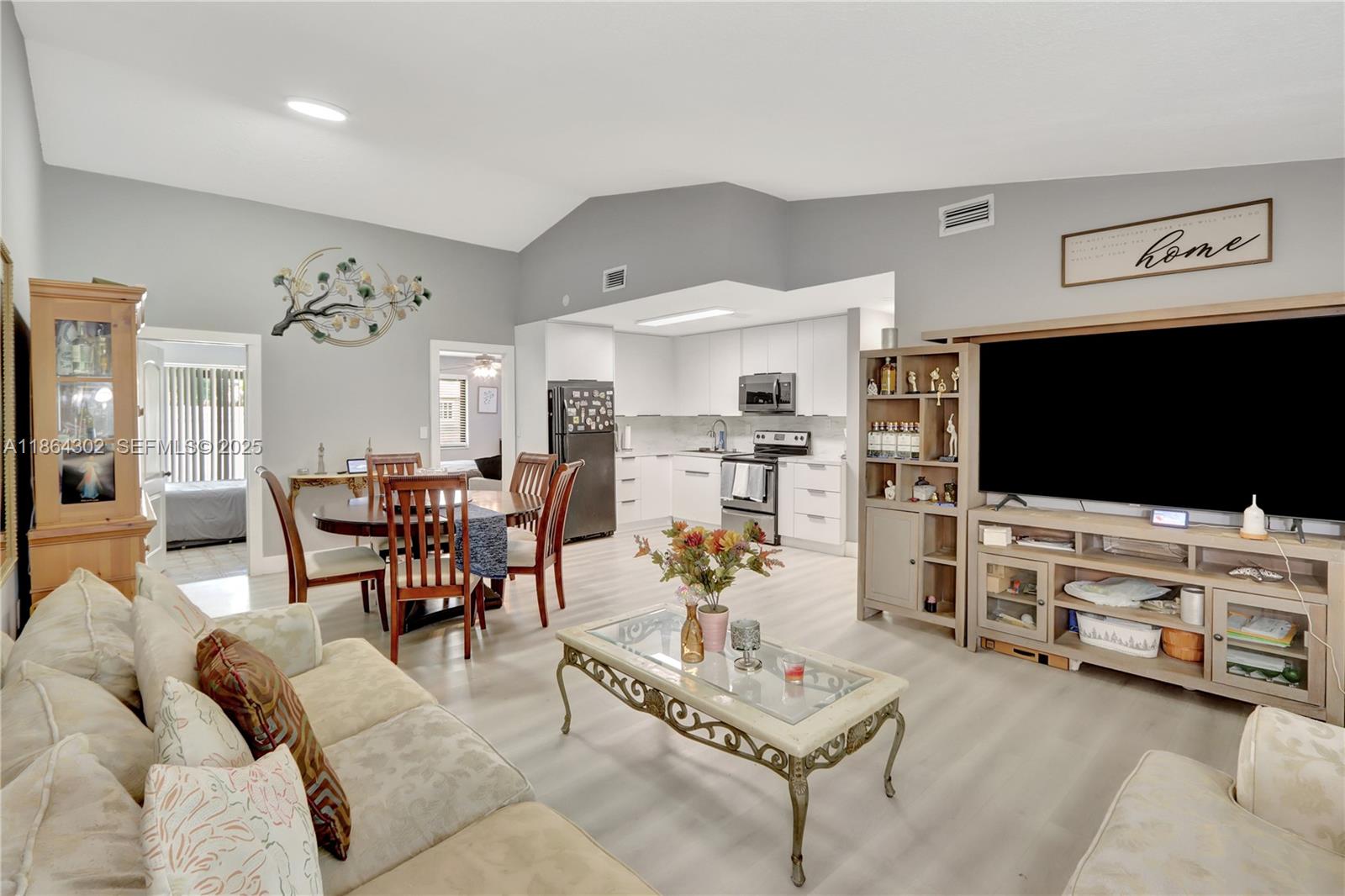 7680 Southwest 156th Court, Unit B113 Miami, FL 33193 - Photo 3 of 16 a living room with furniture and a flat screen tv