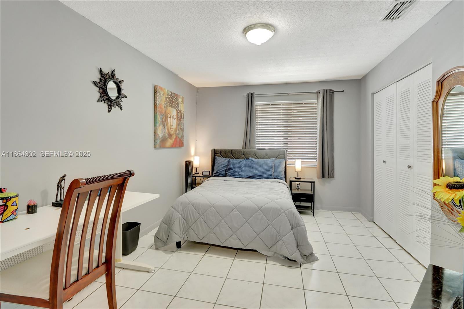 7680 Southwest 156th Court, Unit B113 Miami, FL 33193 - Photo 6 of 16 a bedroom with a bed and a chandelier