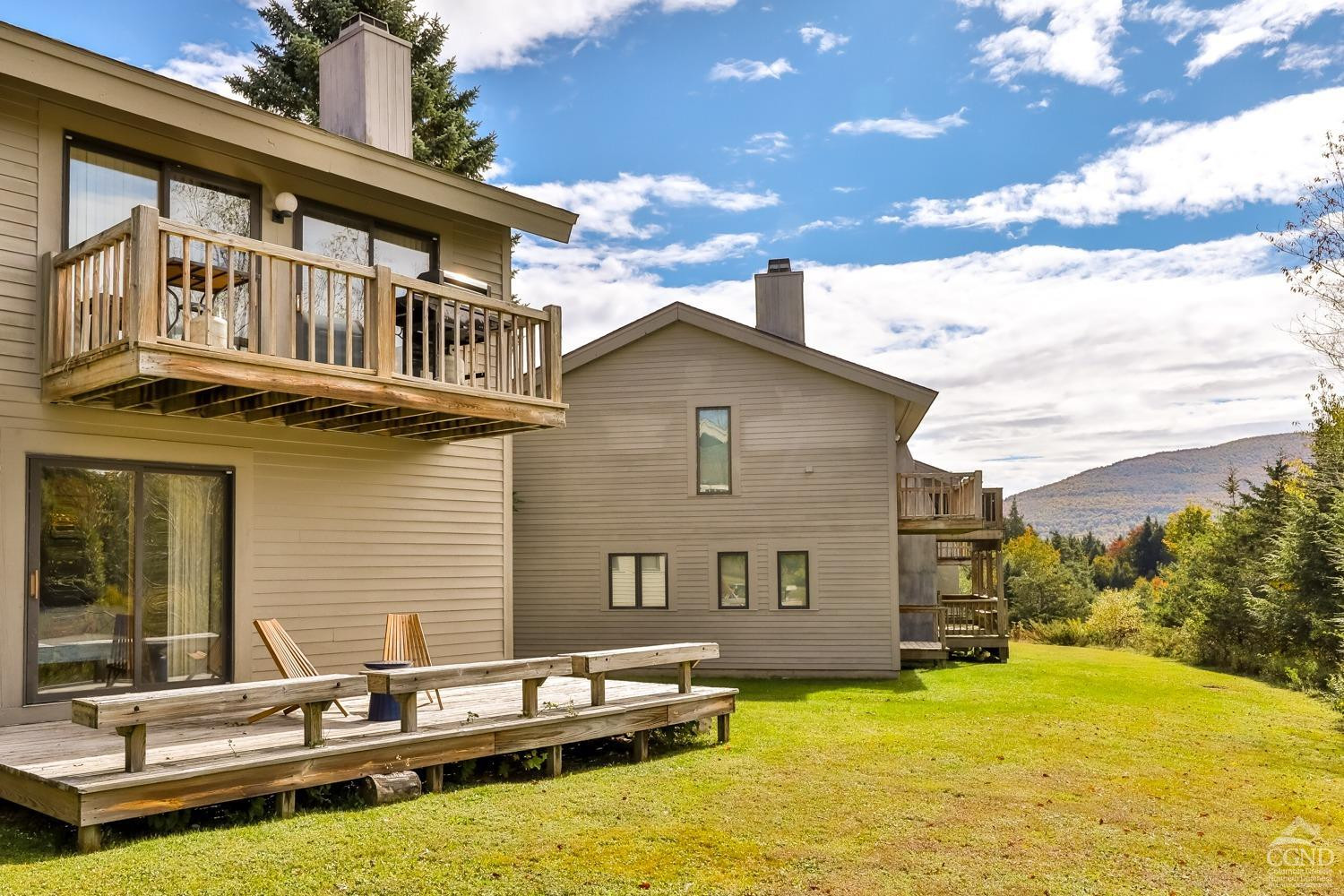 28-1 Loo Bridge Lane, Unit 22A Windham, NY 12496 - Photo 5 of 35 a backyard of a house with yard table and chairs