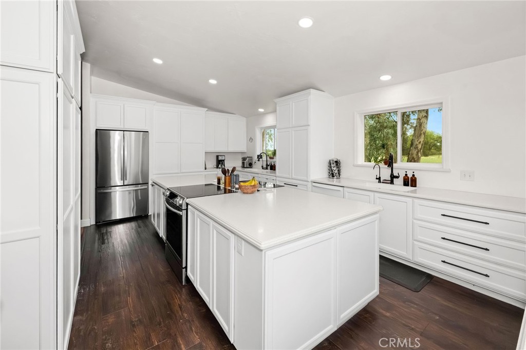 2728 Pentz Road Oroville, CA 95965 - Photo 5 of 52 a kitchen with a refrigerator a sink and cabinets