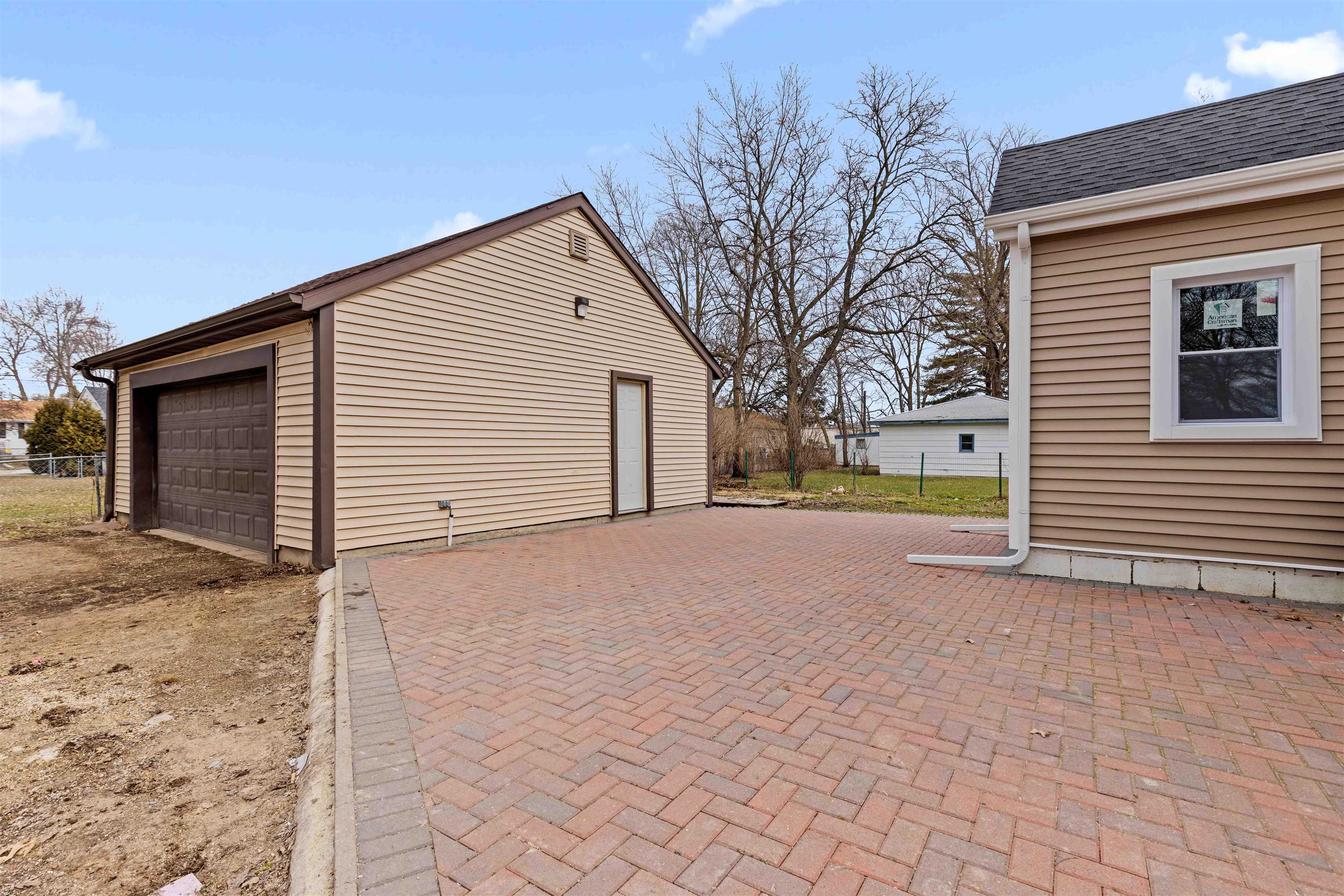1214 Samuelson Road Rockford, IL 61109 - Photo 14 of 15 a view of a house with a yard and garage