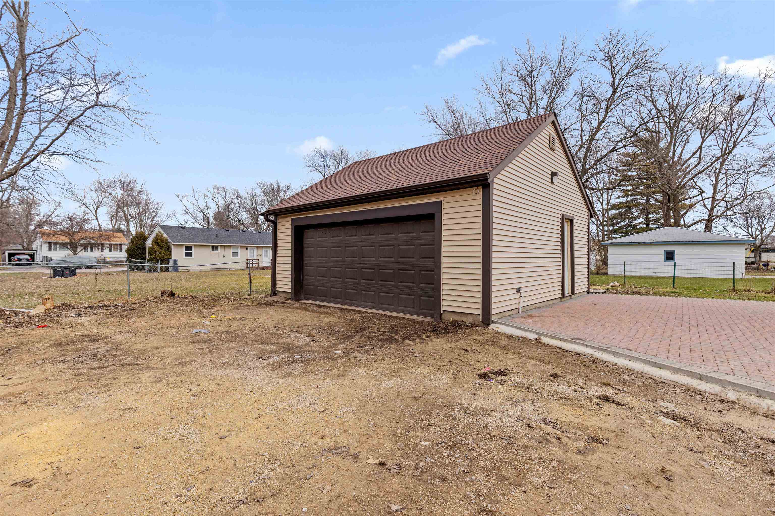 1214 Samuelson Road Rockford, IL 61109 - Photo 15 of 15 a front view of a house with a yard and garage