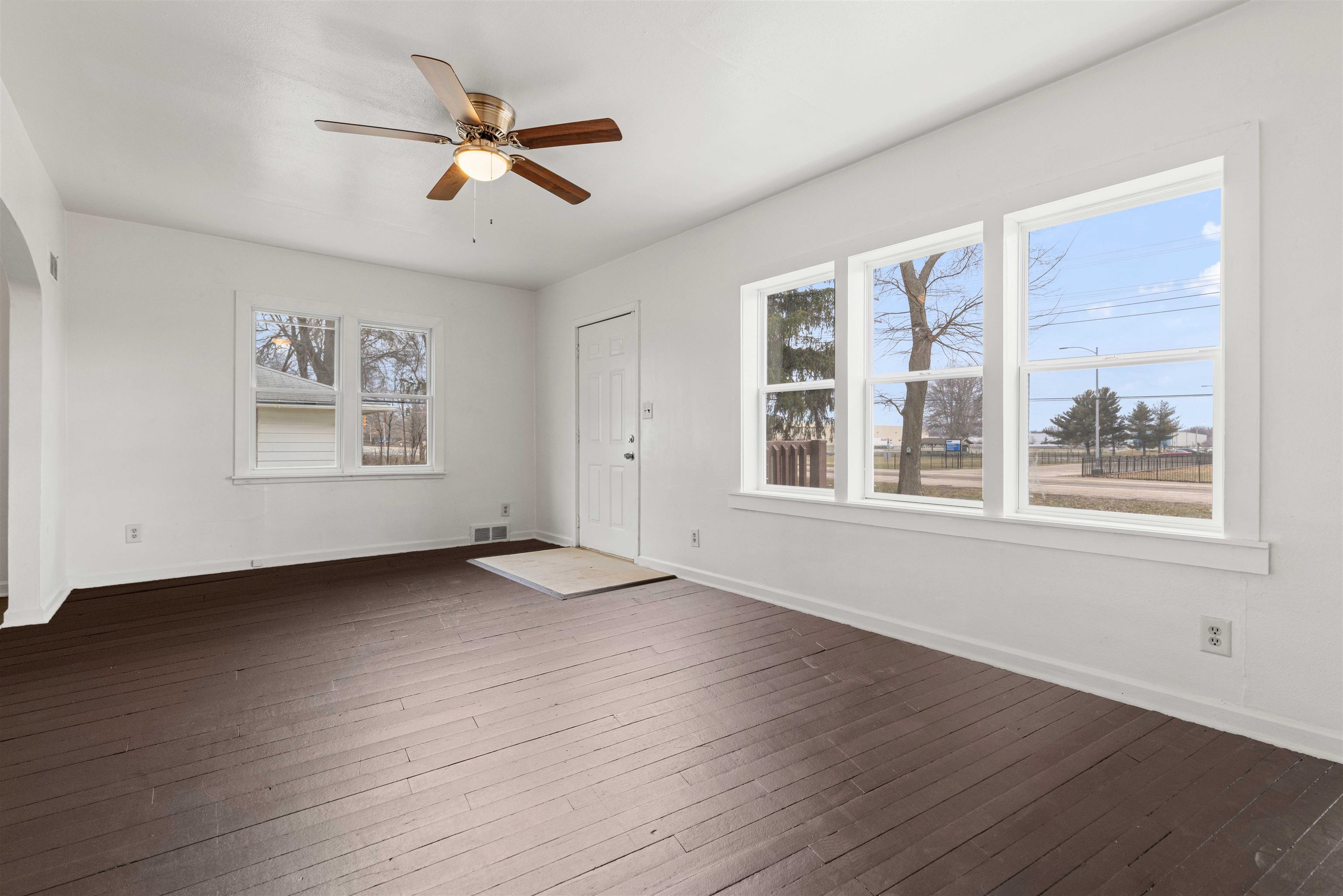 1214 Samuelson Road Rockford, IL 61109 - Photo 3 of 15 a view of an empty room with wooden floor and a window