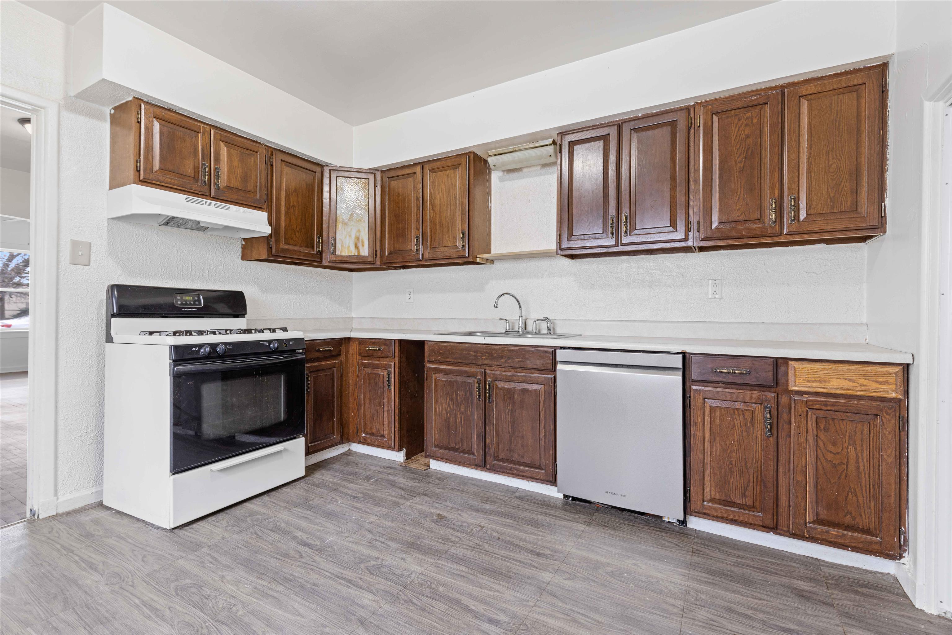 1214 Samuelson Road Rockford, IL 61109 - Photo 5 of 15 a kitchen with granite countertop wooden cabinets and stainless steel appliances