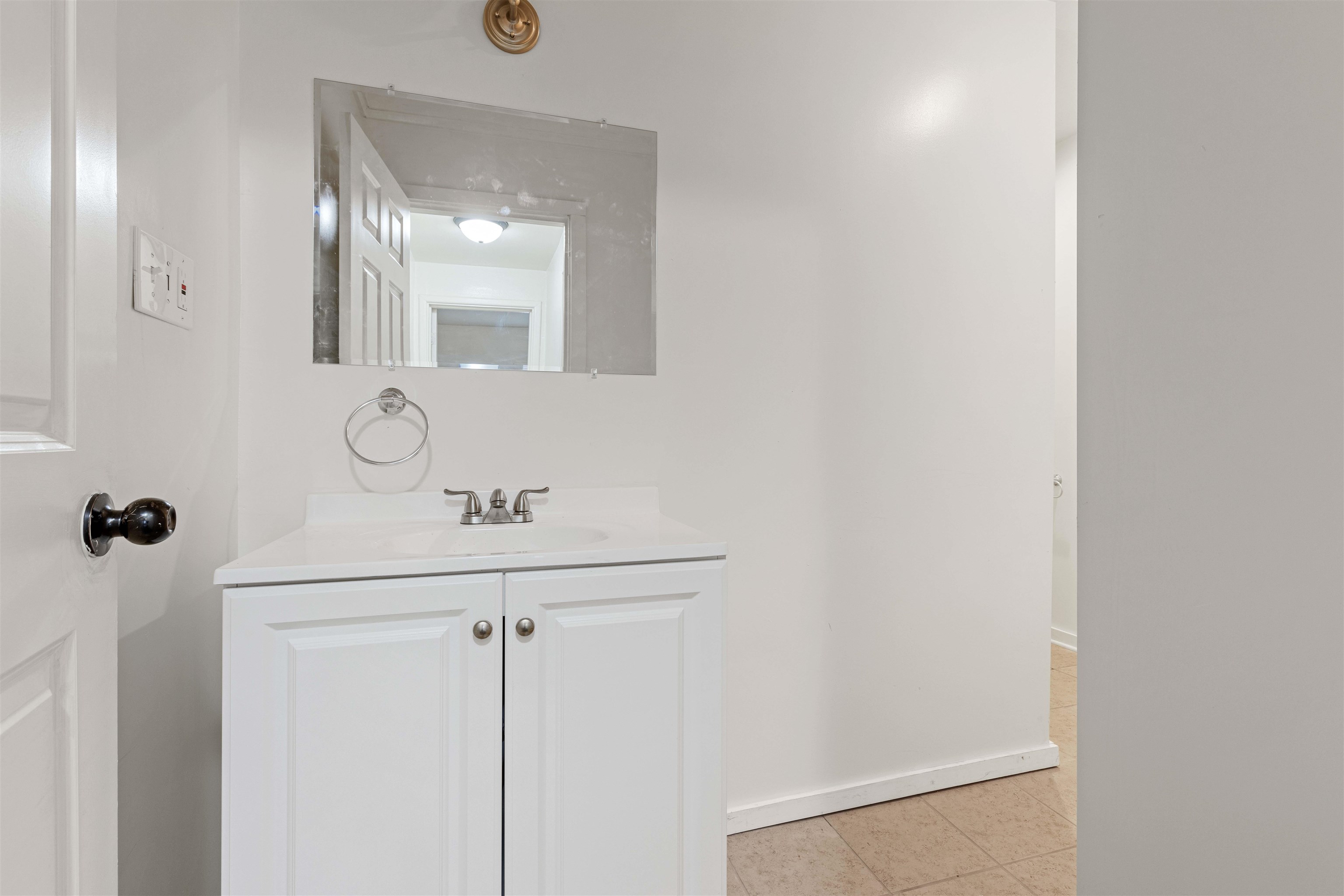 1214 Samuelson Road Rockford, IL 61109 - Photo 7 of 15 a bathroom with a sink a light fixture and a mirror