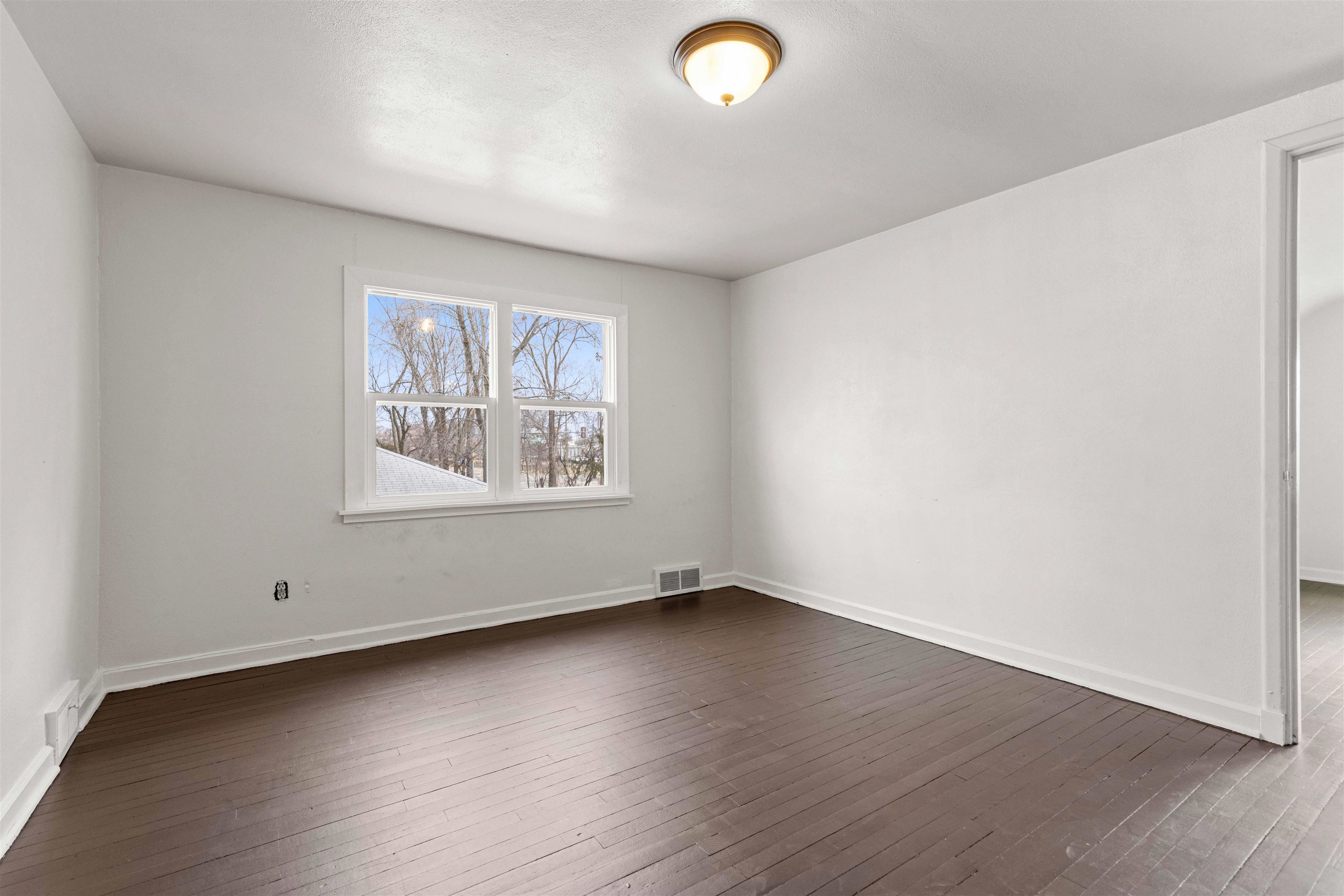 1214 Samuelson Road Rockford, IL 61109 - Photo 10 of 15 an empty room with wooden floor and windows