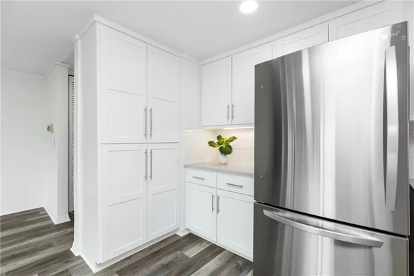 a white refrigerator freezer and a stove sitting inside of a kitchen